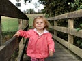 Adorable cute toddler girl walking in a park on autumn day. Happy child having fun outdoors. Autumnal activities with Royalty Free Stock Photo