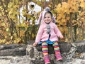 Adorable cute toddler girl walking in a park on autumn day. Happy child having fun outdoors. Autumnal activities with Royalty Free Stock Photo