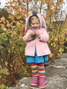 Adorable cute toddler girl walking in a park on autumn day. Happy child having fun outdoors. Autumnal activities with Royalty Free Stock Photo