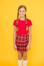 Adorable cutie. Cute little girl charming smile on yellow background. Happy small girl wearing red clothes. Girl with