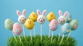 Adorable Easter cake pops with bunny chick and egg designs on a blue background Royalty Free Stock Photo