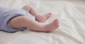 Adorable, family and feet of baby on bed for child care, relax and resting in nursery. Innocent, cute and closeup of Royalty Free Stock Photo