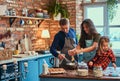 Adorable family together cooking breakfast in loft style kitchen.