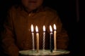 Adorable five year old kid celebrating his birthday and blowing candles on homemade baked cake, indoor. Birthday party for