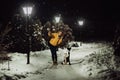 Adorable fluffy cute black and white border colly being trained and petting girl in a park. lights and bushes on the Royalty Free Stock Photo