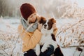 Adorable fluffy cute black and white border colly being trained and petting girl in a park. lights and bushes on the Royalty Free Stock Photo