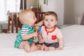 adorable funny baby boys sitting together on bed communicating and playing Royalty Free Stock Photo