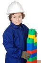 Adorable future builder constructing a brick wall with toy piece Royalty Free Stock Photo