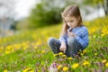 Adorable girl in blooming dandelion flowers Royalty Free Stock Photo