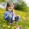 Adorable girl in blooming dandelion flowers Royalty Free Stock Photo