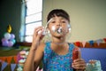 Adorable girl blowing balloon during birthday party Royalty Free Stock Photo