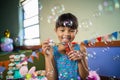 Adorable girl blowing balloon during birthday party Royalty Free Stock Photo