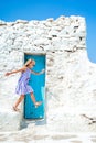 Girl in blue dresses having fun outdoors on Mykonos streets Royalty Free Stock Photo