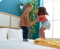 Adorable girl and boy smiling confident jumping on bed at bedroom Royalty Free Stock Photo