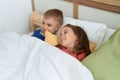 Adorable girl and boy smiling confident lying on bed at bedroom Royalty Free Stock Photo