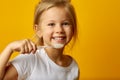 Adorable girl brushing teeth with kids toothbrush