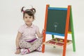 Adorable girl draw a flower on black board with chalk Royalty Free Stock Photo