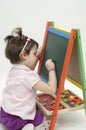 Adorable girl drawing on black board with chalk Royalty Free Stock Photo