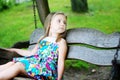 Adorable girl having fun on a wooden swing on summer day Royalty Free Stock Photo