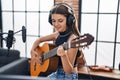 Adorable girl musician singing song playing classical guitar at music studio Royalty Free Stock Photo