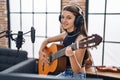 Adorable girl musician singing song playing classical guitar at music studio Royalty Free Stock Photo