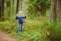 Adorable girl picking foxberries in the forest Royalty Free Stock Photo