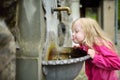 Adorable girl playing with drinking water fountain in Lindau, Germany Royalty Free Stock Photo