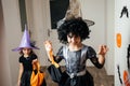 Adorable girl posing in pink dress and witch hat Royalty Free Stock Photo