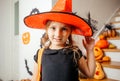 Adorable girl posing in pink dress and witch hat Royalty Free Stock Photo