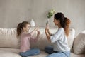 Adorable girl practicing communication with caring mum.