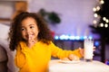 Adorable girl preparing milk and cookies for Santa Claus Royalty Free Stock Photo