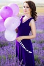 Adorable girl with purple balloons.