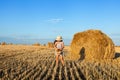 Adorable girl in rye field on sunset with a basket of bread Royalty Free Stock Photo