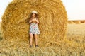 Adorable girl in rye field on sunset with a basket of bread Royalty Free Stock Photo