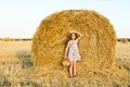 Adorable girl in rye field on sunset with a basket of bread Royalty Free Stock Photo