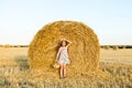 Adorable girl in rye field on sunset with a basket of bread Royalty Free Stock Photo