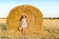 Adorable girl in rye field on sunset with a basket of bread Royalty Free Stock Photo