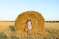 Adorable girl in rye field on sunset with a basket of bread Royalty Free Stock Photo