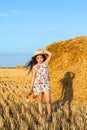 Adorable girl in rye field on sunset with a basket of bread Royalty Free Stock Photo