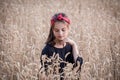 Adorable girl standing on wheat field Royalty Free Stock Photo