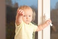 Adorable girl stay on the window sill Royalty Free Stock Photo