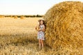 Adorable girl in rye field on sunset with a basket of bread Royalty Free Stock Photo