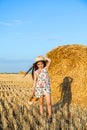 Adorable girl in rye field on sunset with a basket of bread Royalty Free Stock Photo
