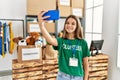 Adorable girl wearing volunteer uniform make selfie by the smartphone at charity center Royalty Free Stock Photo