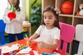 Adorable girls student cutting paper playing trumpet at kindergarten Royalty Free Stock Photo