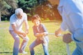 Adorable grandfather cheering for grandson competing with father Royalty Free Stock Photo