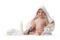 Adorable happy baby smiling under a white towel with teeth brush. Bath time. Royalty Free Stock Photo