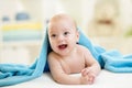 Adorable happy baby in towel indoor