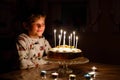 Adorable happy blond little kid boy celebrating his birthday. Child blowing candles on homemade baked cake, indoor Royalty Free Stock Photo