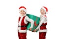 Adorable happy boys in santa clothes holding Christmas gift box. Isolated white background. Royalty Free Stock Photo